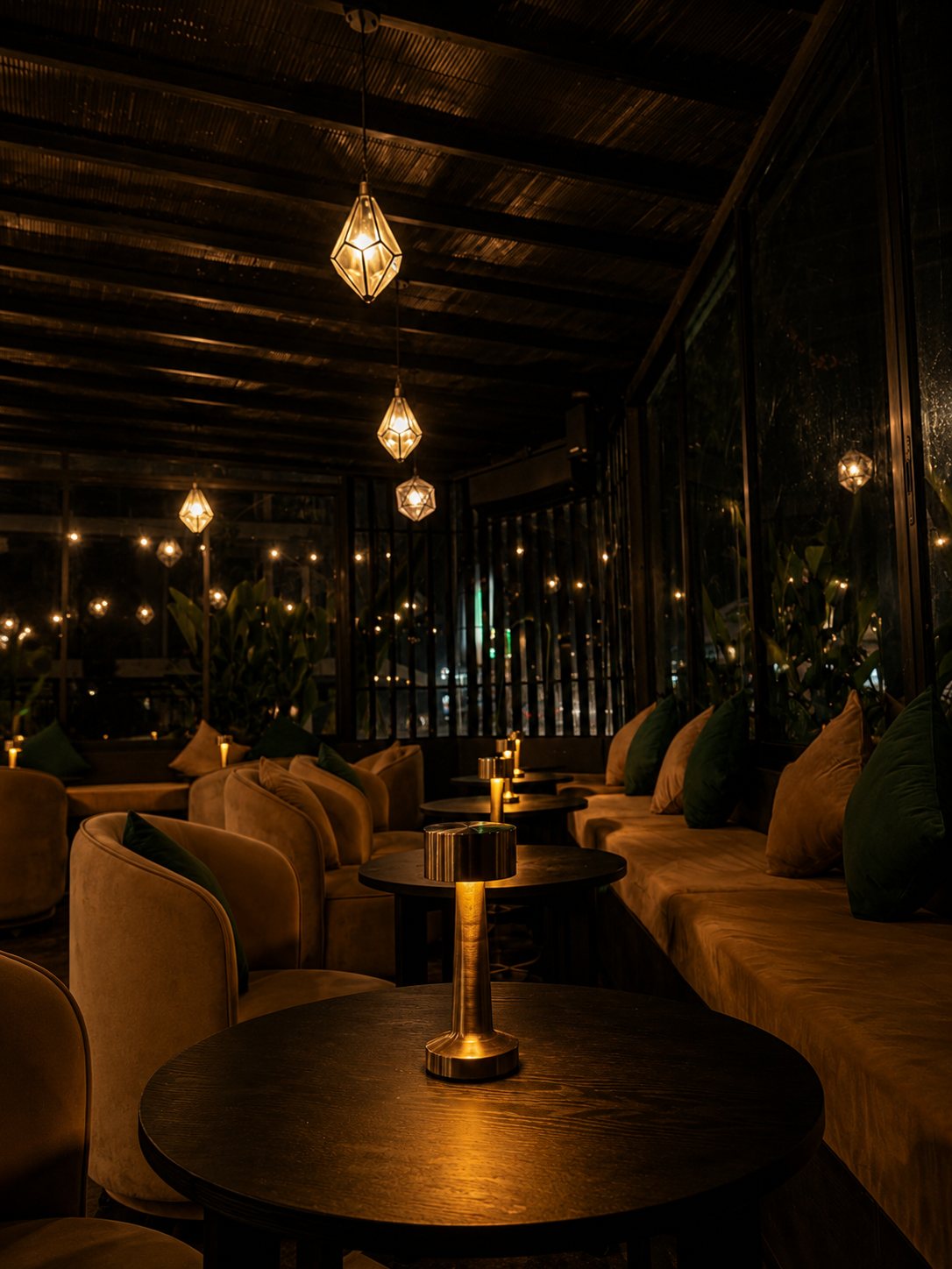 Velvet chairs around candlelit tables